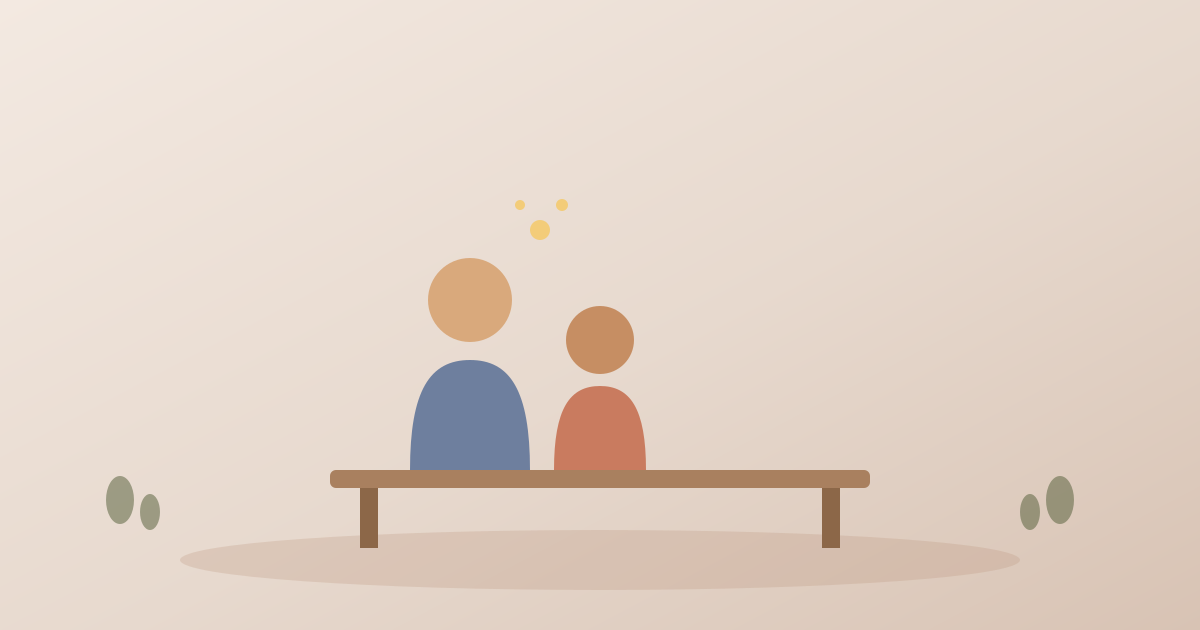 An adult and a student sitting together on a bench, having a supportive conversation